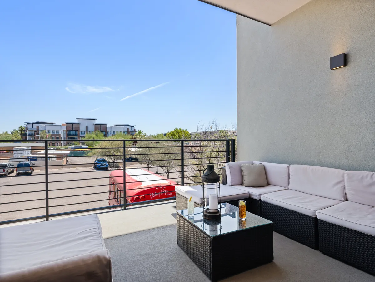 A casual and welcoming outdoor seating area with a table and lantern, overlooking the surrounding area. The setup invites group gatherings and casual conversation, perfectly suited for pre- or post-nightlife relaxation.